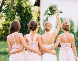 Bride and bridesmaids in open back dresses