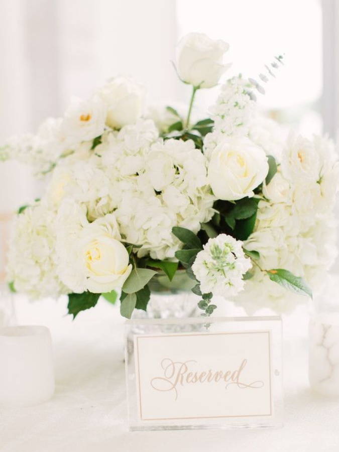 All-white centerpiece and acrylic table number