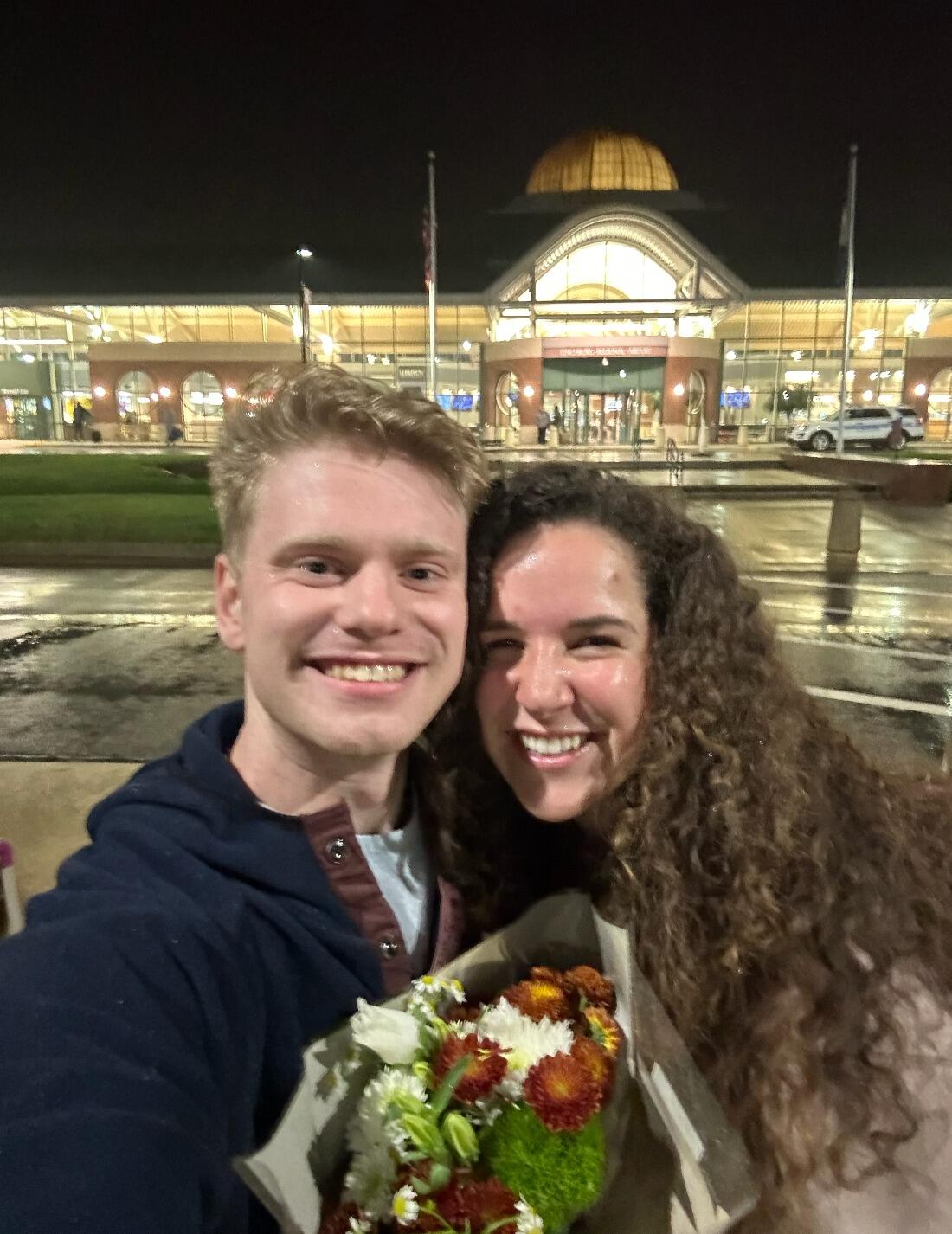 After Em went away to Texas for a few days, Michael picked her up at the airport with flowers and asked her to be his girlfriend.