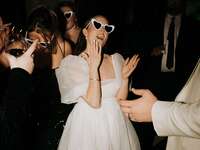 Brides wearing heart sunglasses at reception