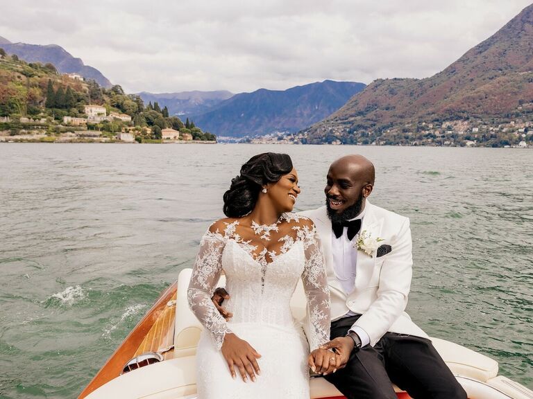 The happy couple share a moment together on a boat in the middle of a lake
