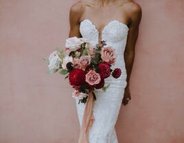 bride wearing strapless sweetheart gown holds wedding bouquet