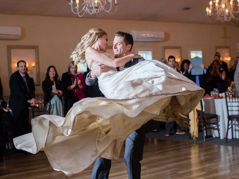 Groom spinning his bride around the dance floor