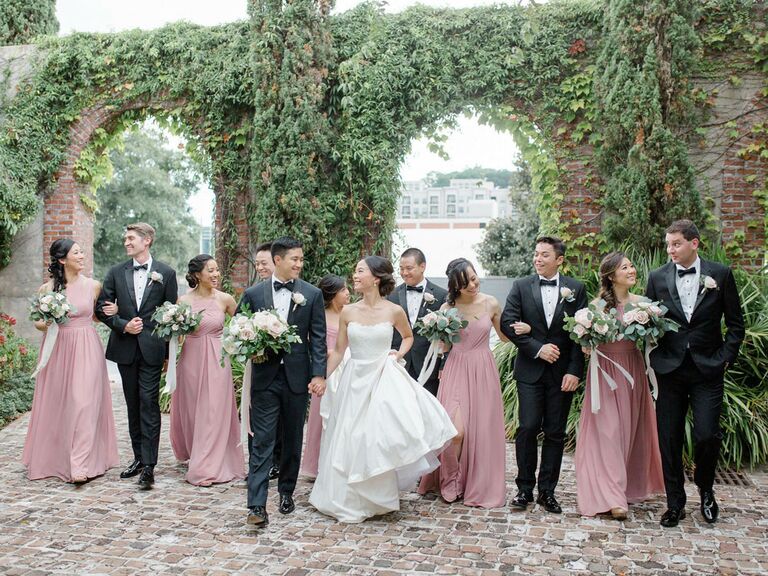 Bridesmaid picture with groomsmen at outdoor venue