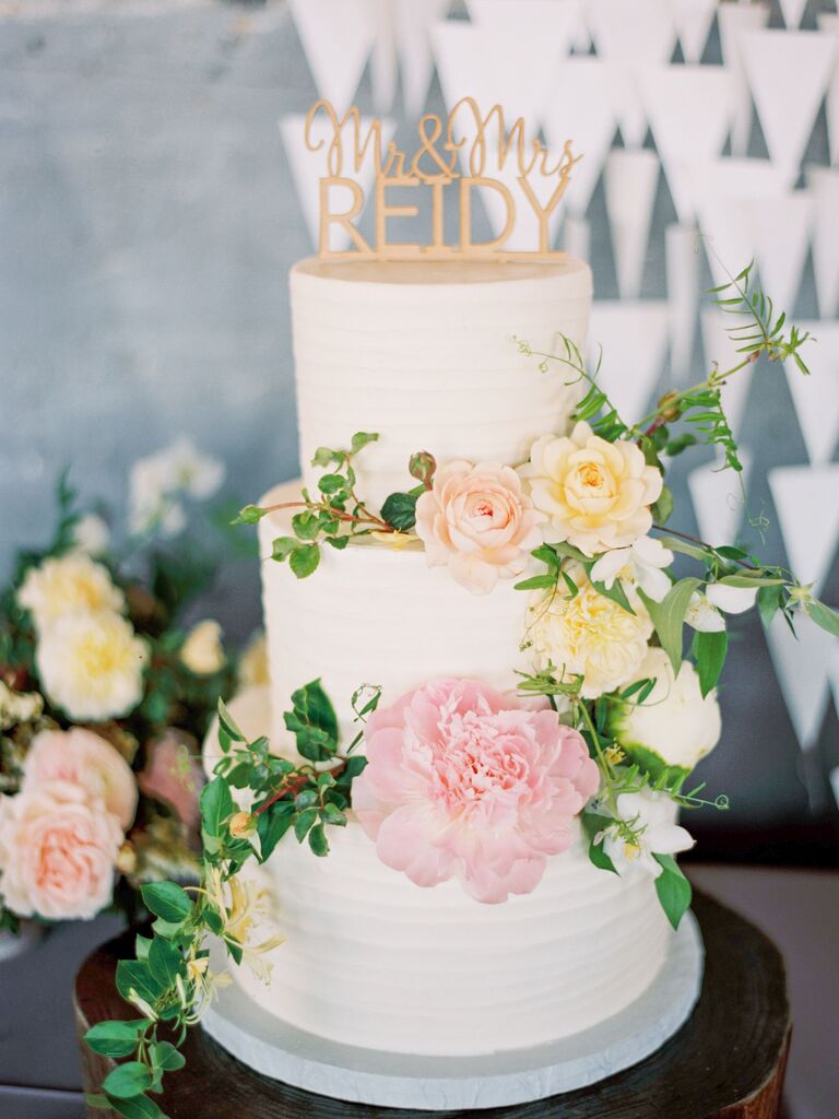 This cake reaches for springtime heights with a pale pink, peach and yellow color scheme.