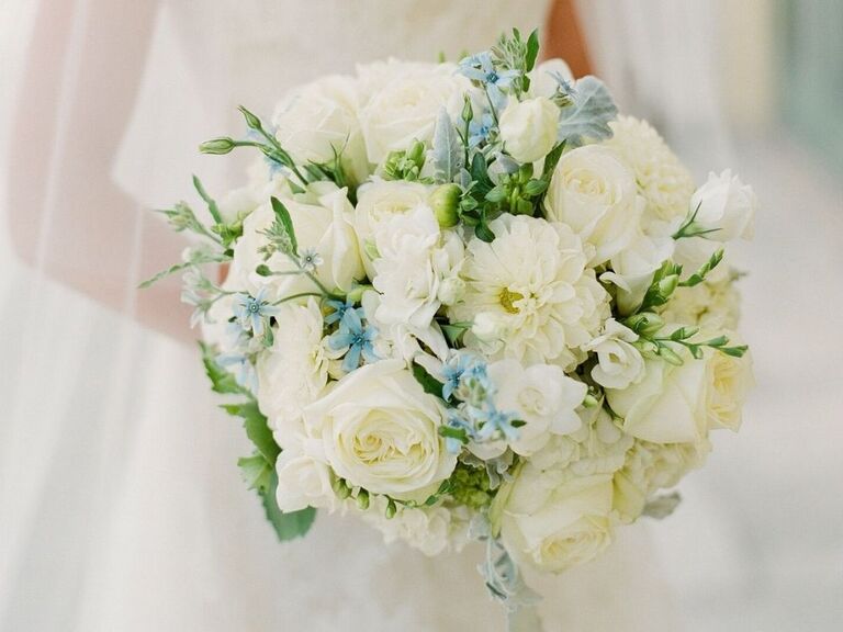 white bouquet with blue tweedia accents
