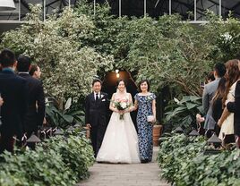 Bride walking down the aisle with parents