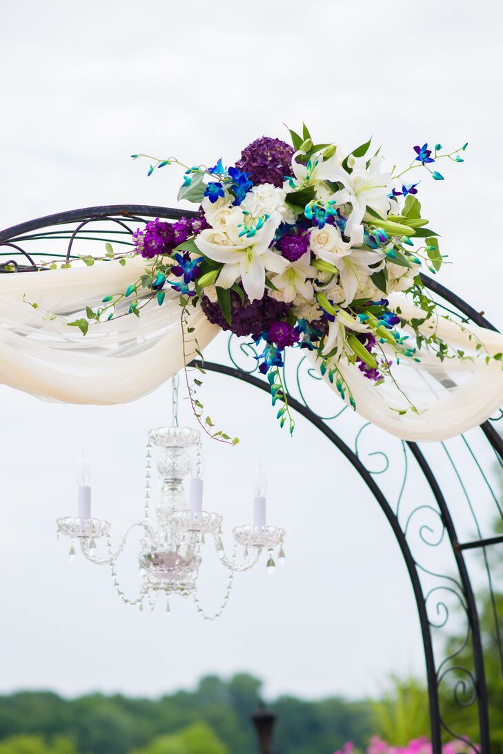 Wedding Arch With Purple And Blue Flowers And A Candelabra