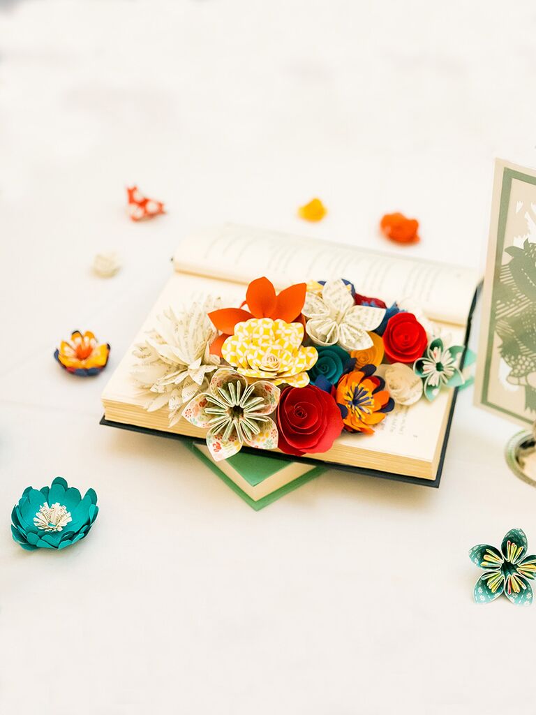 Non-floral centerpiece idea with paper flowers and books