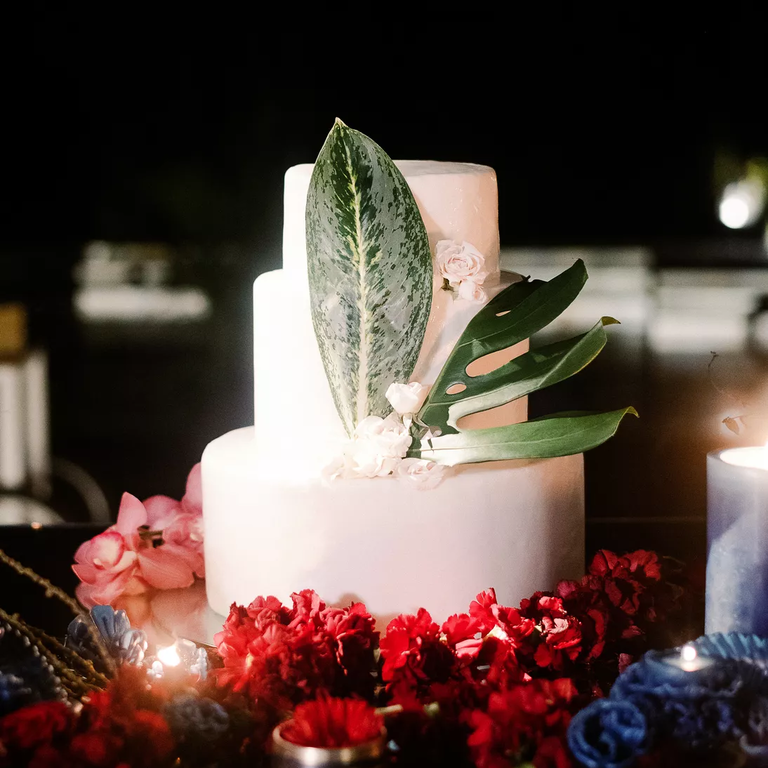 White wedding cake with tropical leaves