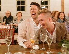 Couple laughs during their rehearsal dinner. 