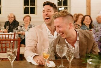 Couple laughs during their rehearsal dinner. 