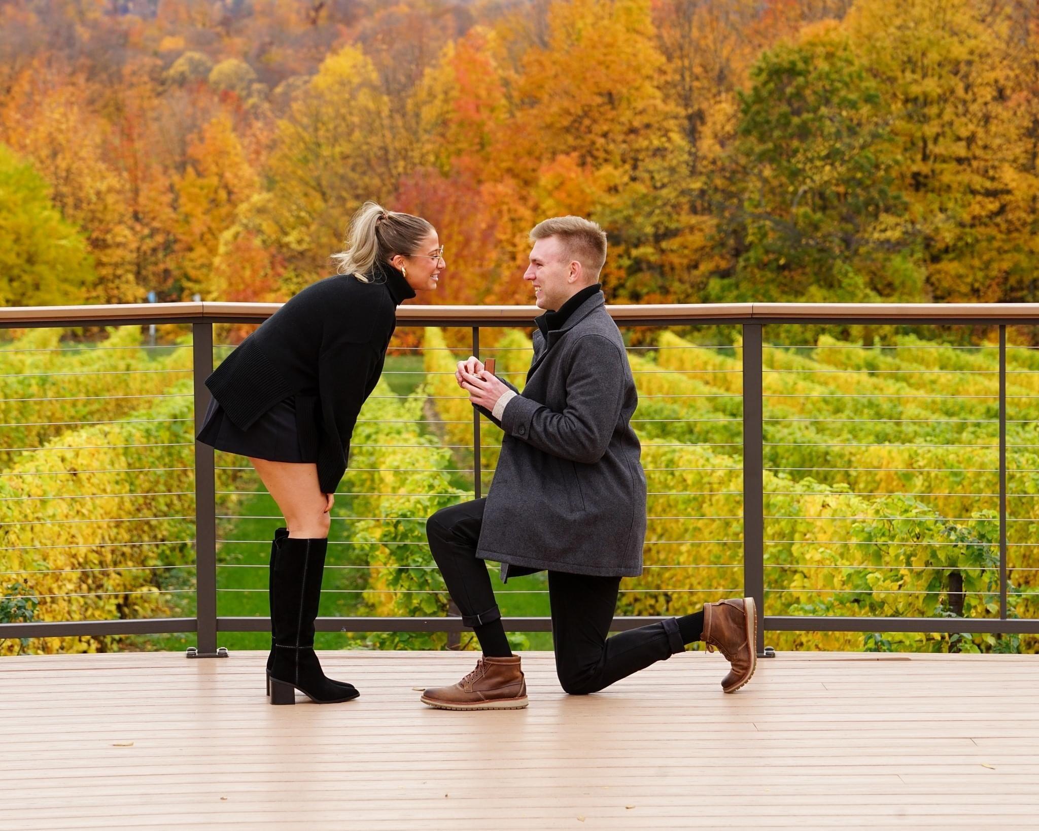 After 6 years together, Alex proposed at the most beautiful spot in Traverse City. Alex and Madison checked into their AirBnB on Grand Traverse Resort and went to dinner Friday night, where he gifted her a pair of diamond earrings to "throw her off." 

On Saturday, they did their favorite thing together - walked to get coffee. 

Then, Alex told Madison to get dressed up to go to the wineries. Alex proposed at Chateau Grand Traverse, on the private patio, looking out at the stunning scenic view. 