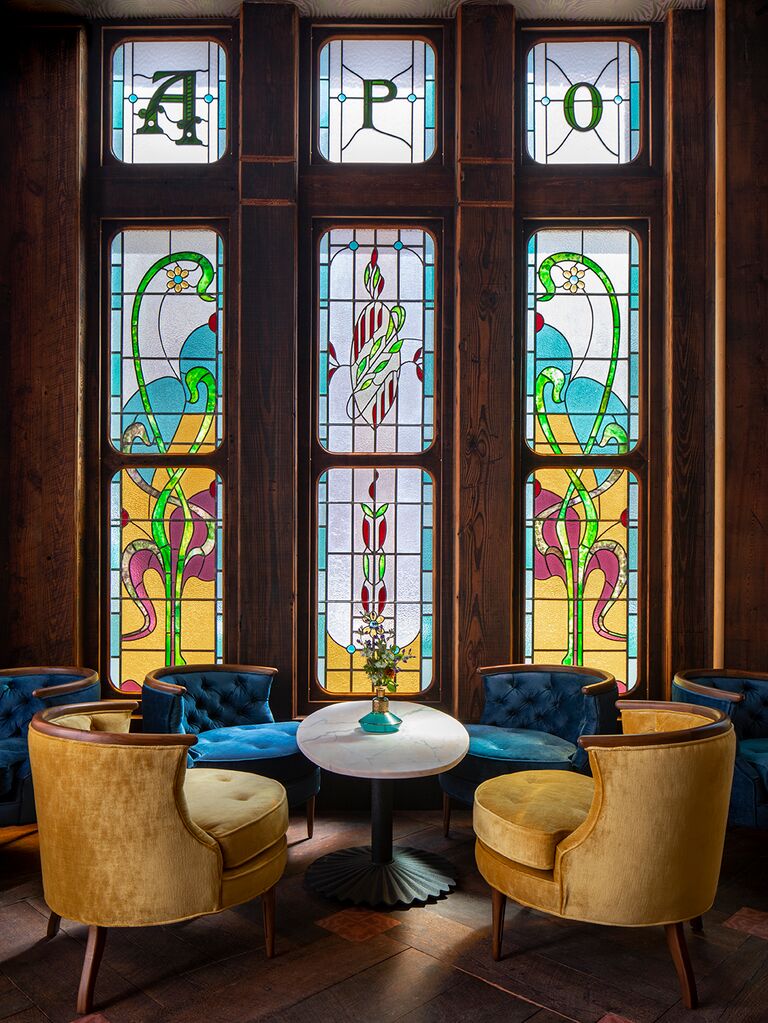 Gorgeous seating area with stained glass windows at Apotheke Nomad