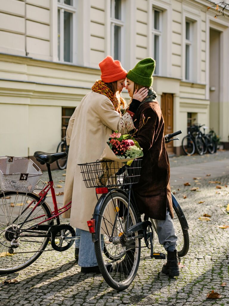 a cute couple embracing on bikes