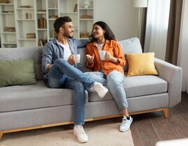 Couple having a conversation on the sofa