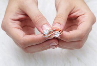 Woman holding different diamond engagement rings