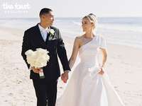 Michael Norman and wife Jenna Adams holding hands on their wedding day