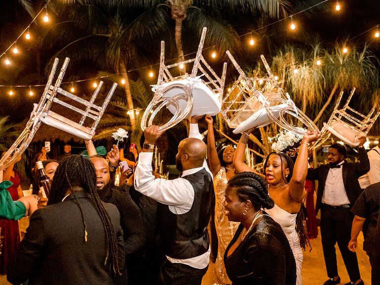 Emmy Petit's wedding guests dancing with chairs at the reception