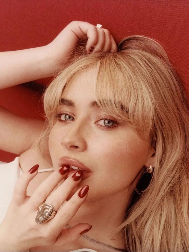 Sabrina Carpenter with red heart nails