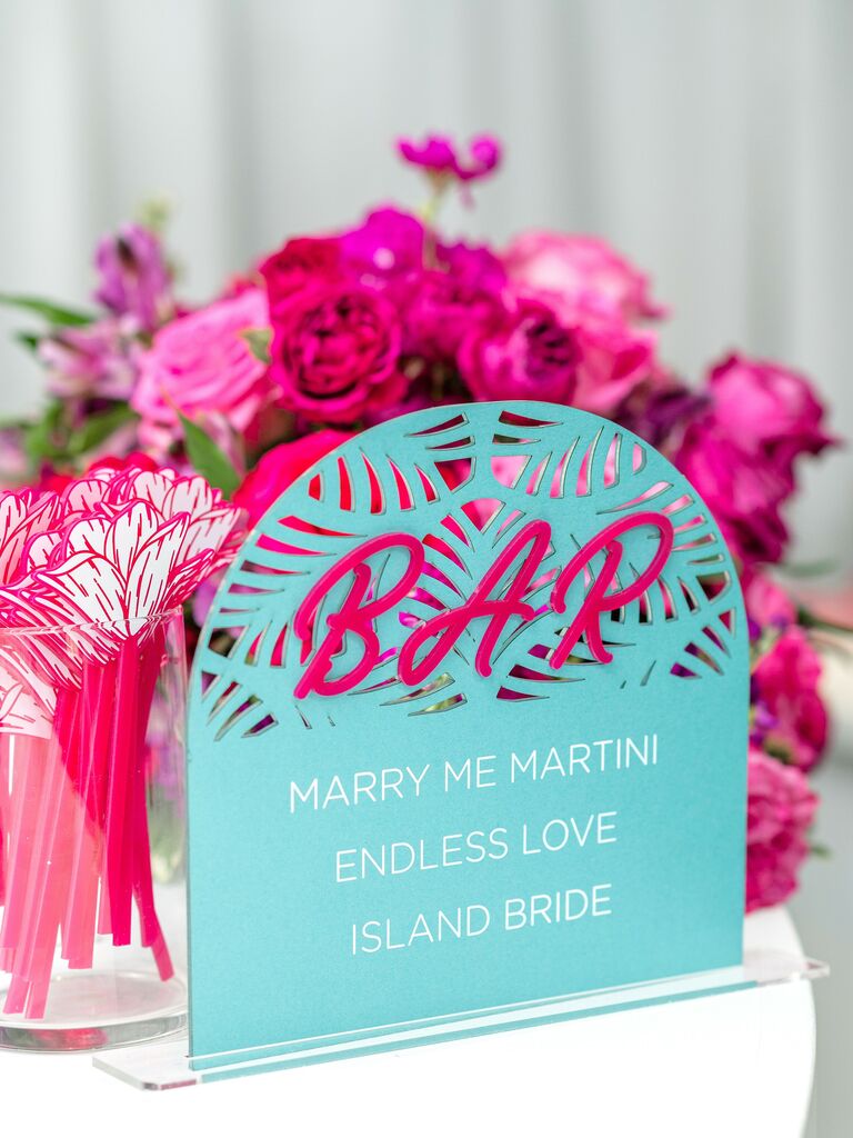 acrylic wedding bar sign with hot pink lettering on turquoise background