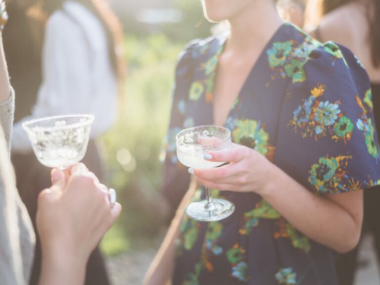 Guests drink out of vintage glasses at party