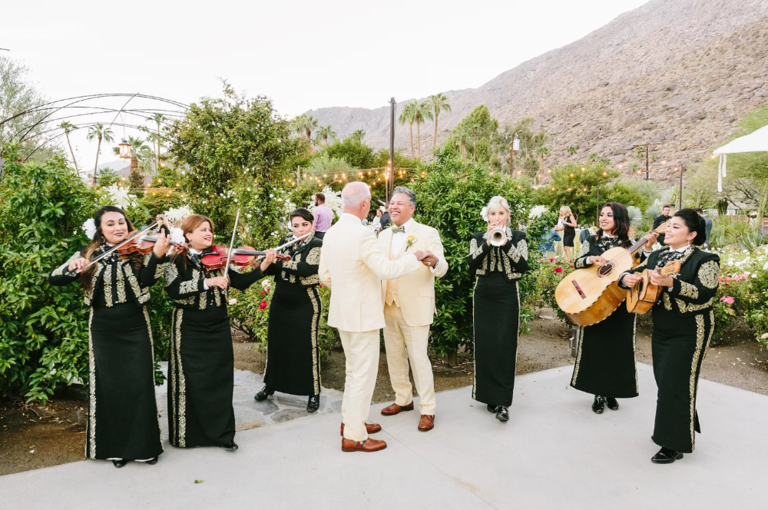 Grooms dancing while Mariachi band plays
