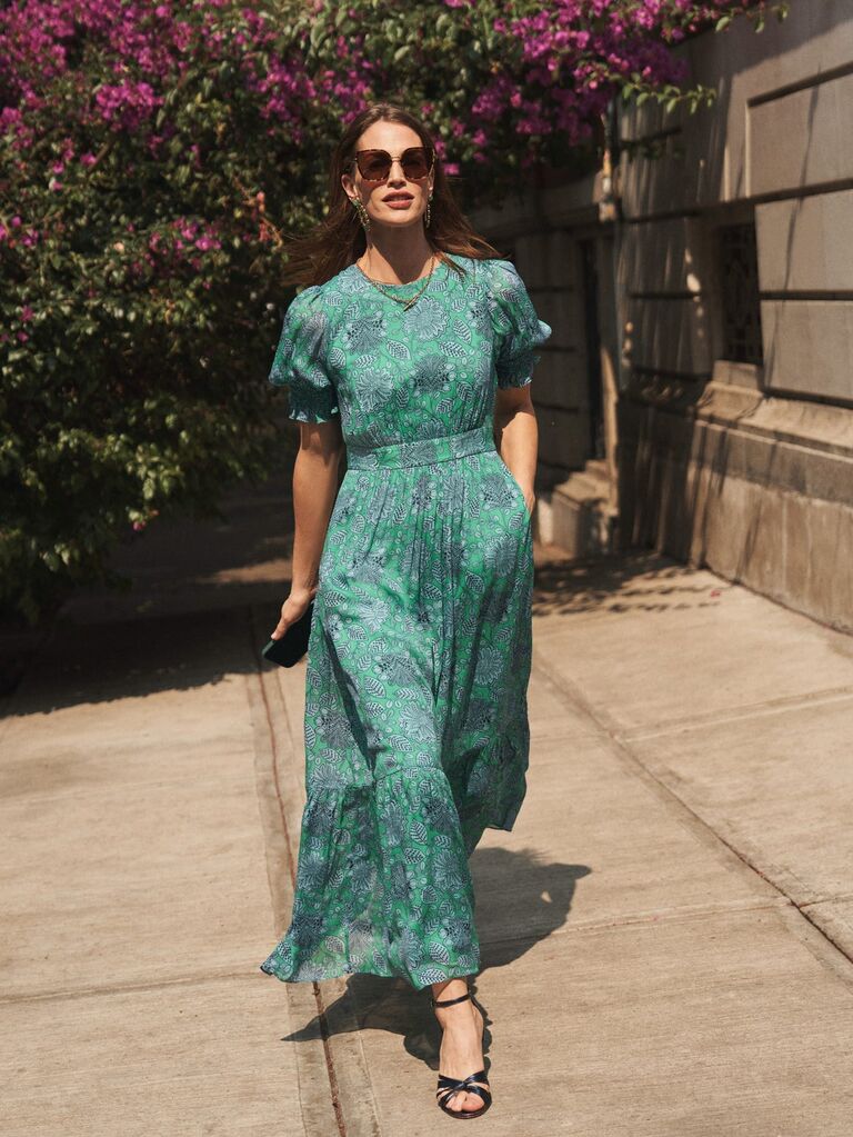 Woman wearing green smocked cuff maxi dress outdoors