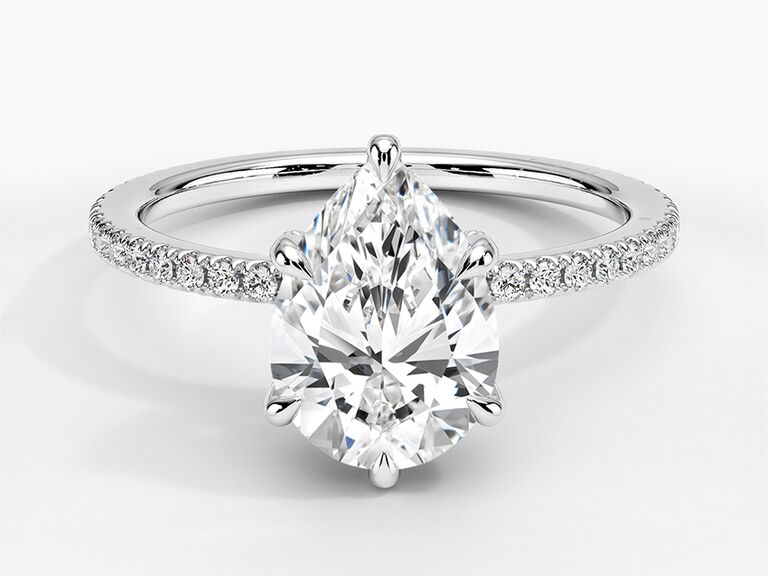four-prong classic oval engagement ring with pavé diamond band