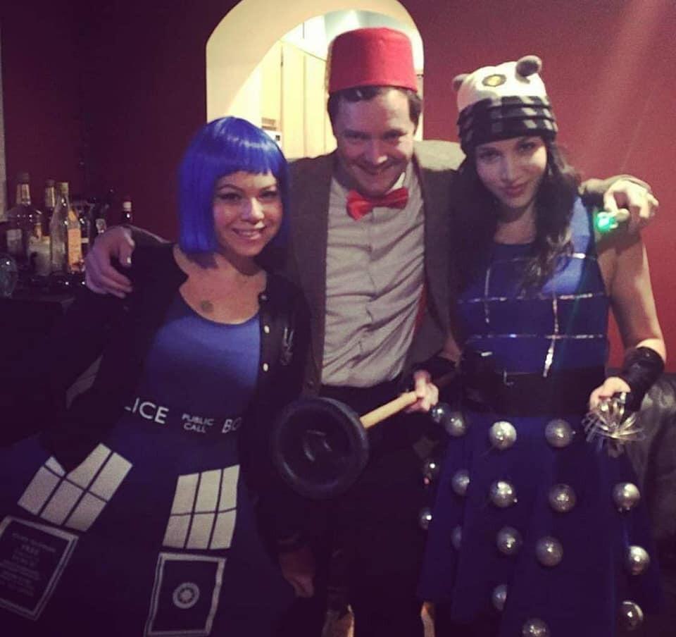 A year flies by. Emmanuel sees this exact picture of Shannon dressed as a Dalek for Halloween on Facebook. There is no doubt in his mind that she is the Queen of Cosplay. He throws back a shot of whiskey and writes a Facebook message declaring how he feels. Shannon is moved by his courtly display of affection and agrees to go on a second-first date.