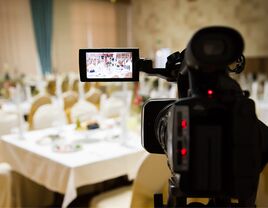 Video camera filming at wedding