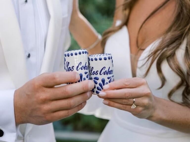 Couple using their personalized shot glasses on their wedding day