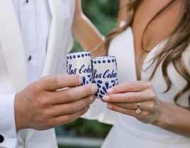 Couple using their personalized shot glasses on their wedding day