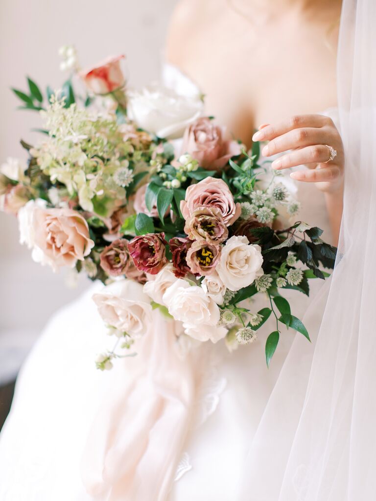 romantic winter wedding bouquet with blush and mauve roses, smilax and white astrantia
