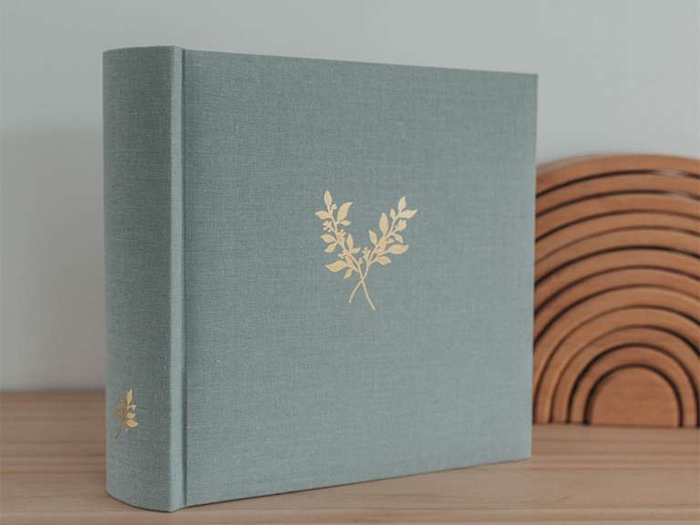 Linen photo album with gold greenery sprig stamp on front