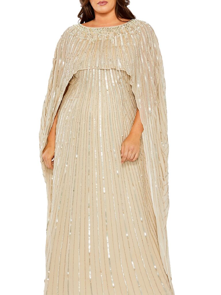 Model wearing a gown with cape and sequins