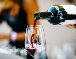 red wine being poured into a glass