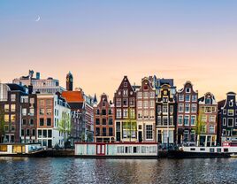 amsterdam with crescent moon hovering over city iconic landmarks