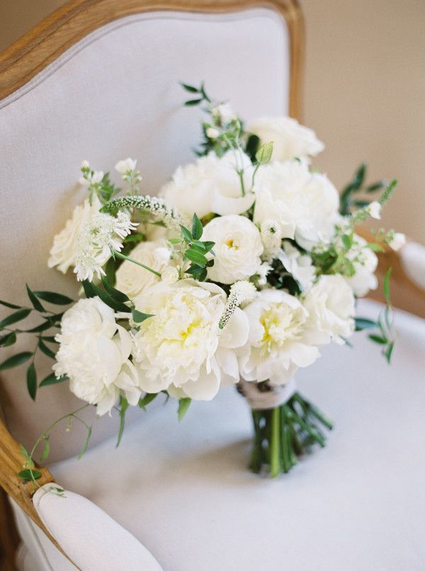 Classic white-and-green bouquet sitting on chair
