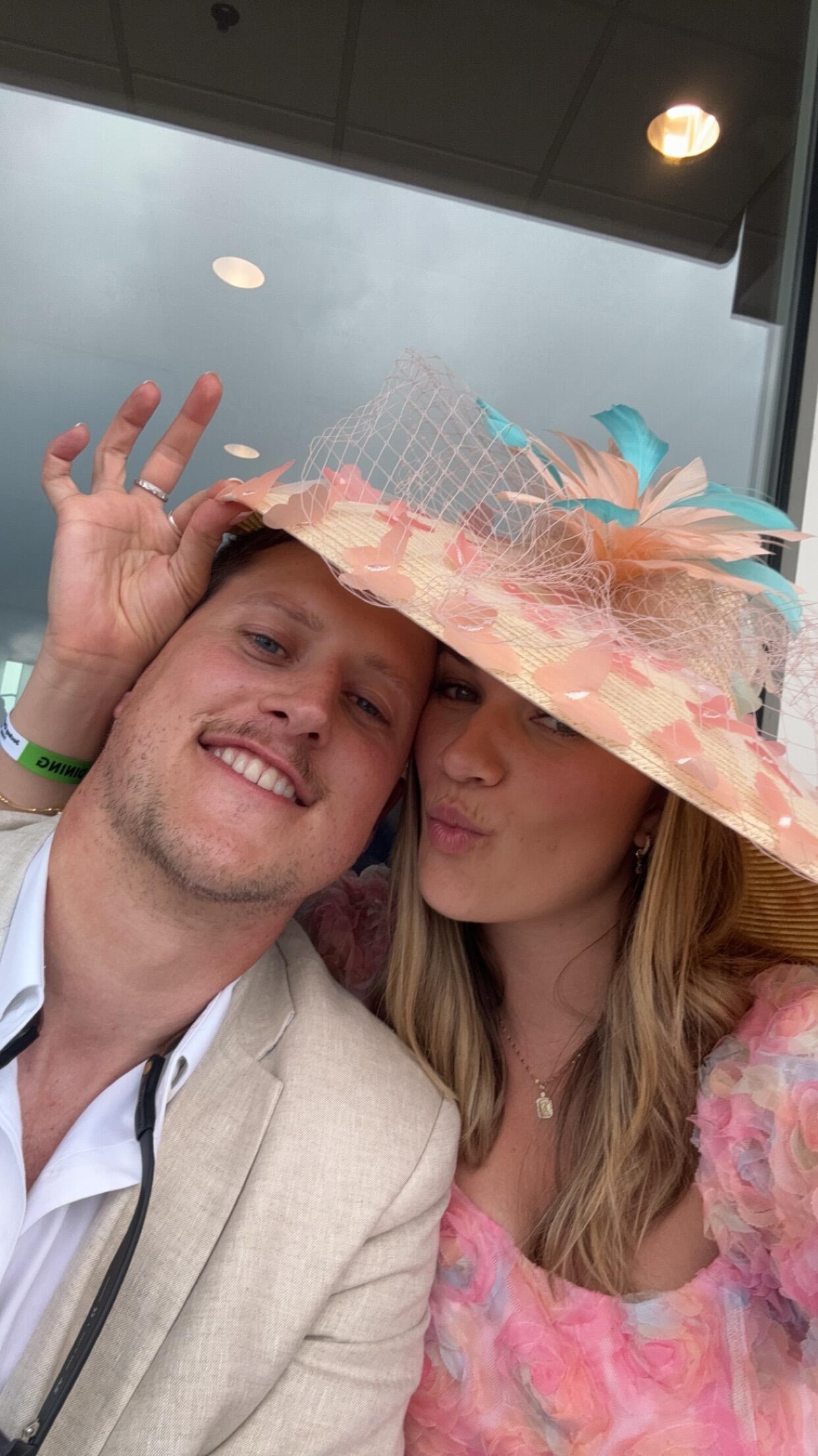 More fun getting dressed up at the track! Thankfully there was enough room for us to take cover from the rain under my hat. 