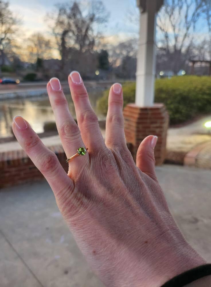 The stone (peridot) is special because it is Tyler's birthstone. His mother had a ring with her sons' birthstones on it, and she graciously gave Tyler's stone to him for the engagement ring. 