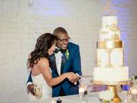 bride and groom cutting gold wedding cake