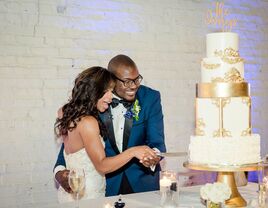 bride and groom cutting gold wedding cake