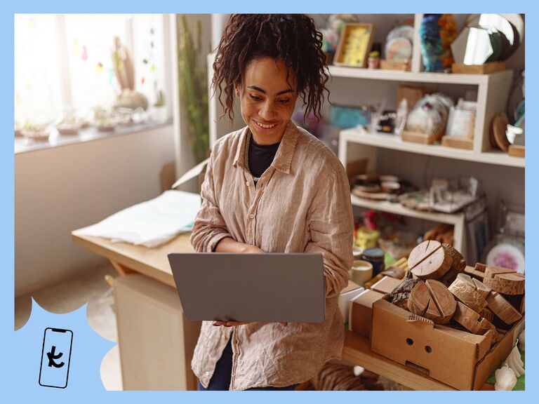 Woman standing while looking at a laptop