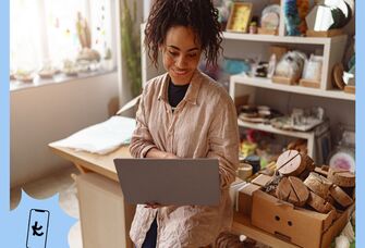 Woman standing while looking at a laptop