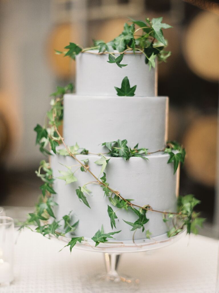 three tier fondant wedding cake decorated with green ivy vines