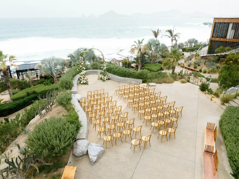 Wedding ceremony hosted on hotel balcony overlooking ocean at The Cape Hotel in Cabo San Lucas, Mexico