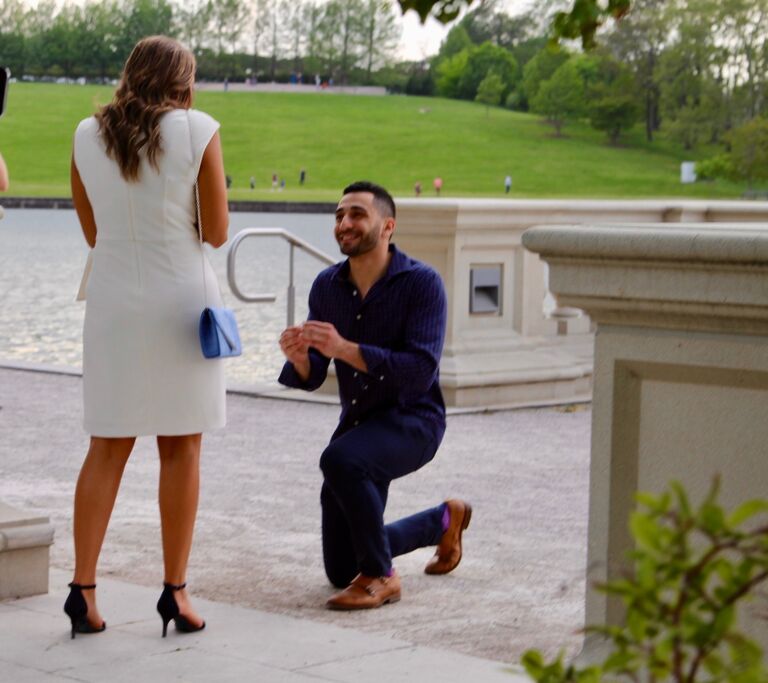 Fast forward to a beautiful spring day in St. Louis, Missouri, where George decided to take the next step in their journey. Outside an art museum, surrounded by the beauty of nature, he got down on one knee. However, George, in the excitement of the moment, got on one knee twice – not because he was nervous, but because he momentarily forgot which pocket the ring was in. 