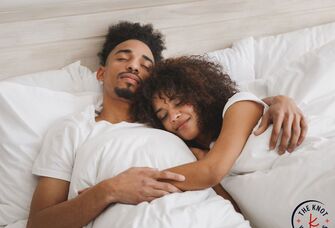 Couple cuddling on one of the best mattress for couples