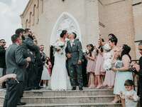 bride and groom kiss on steps of church after christian wedding ceremony